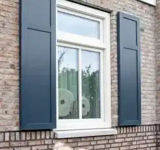 PVC window with shutters on a Dutch facade